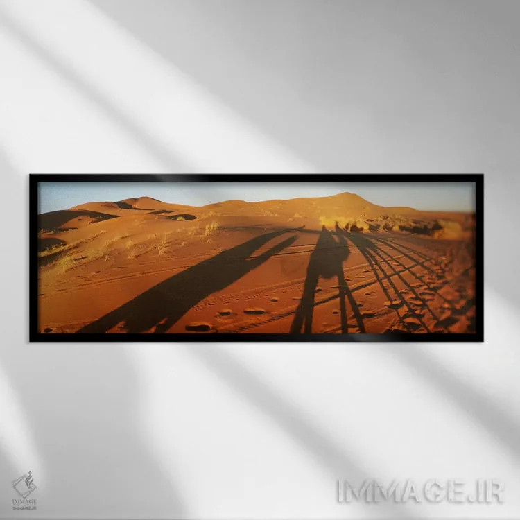 تابلو دکوراتیو Sahara Desert, Morocco,سایه شترسواران در صحرا هنگام غرو… اثر پانورامیک ایمجز - نمای قابدار مشکی