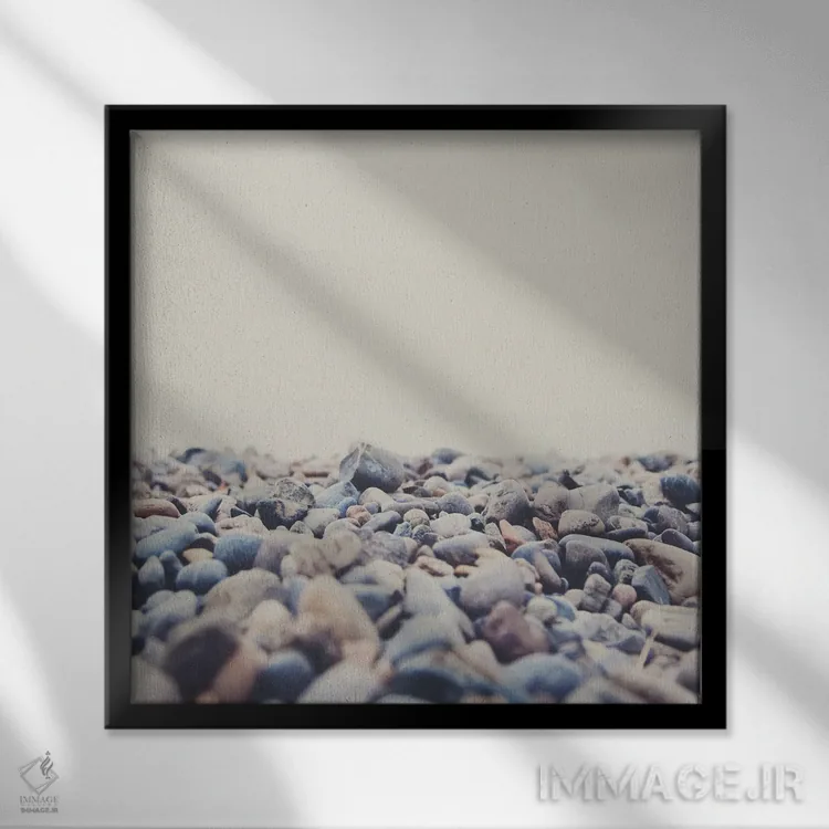 تابلو دکوراتیو سنگ ریزه های ساحل دریاچه کنستانس اثر لورا ایوانز - نمای قابدار مشکی
