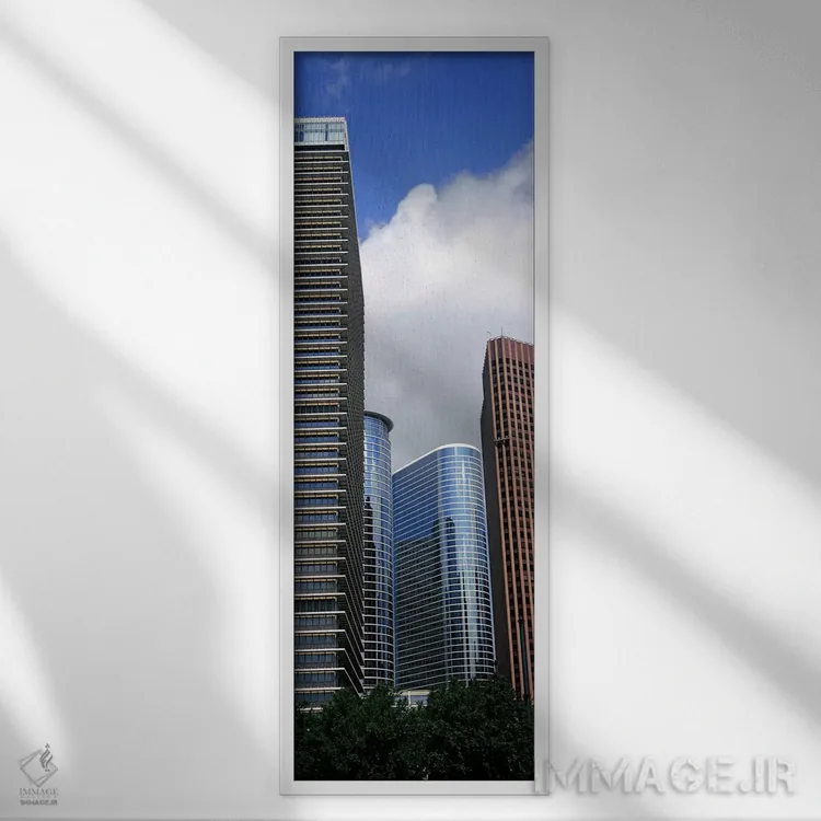 تابلو دکوراتیو نمای پایین از ساختمان ها در یک شهر، برج وج، ساختمان اکس… اثر پانورامیک ایمجز - نمای قابدار سفید