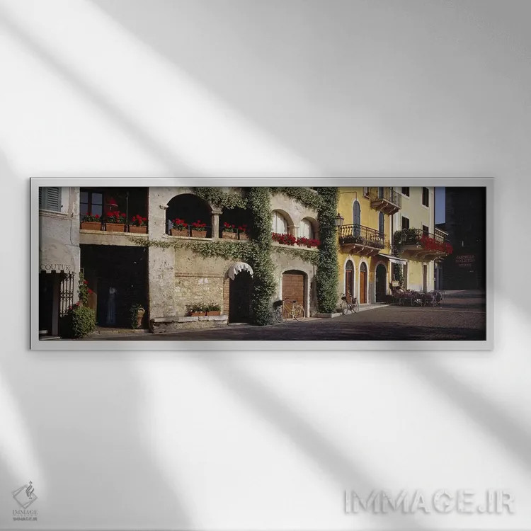 تابلو دکوراتیو Torri del Benaco, Verona, Italy,کوچه سنگ فرش با جعبه ها… اثر پانورامیک ایمجز - نمای قابدار سفید