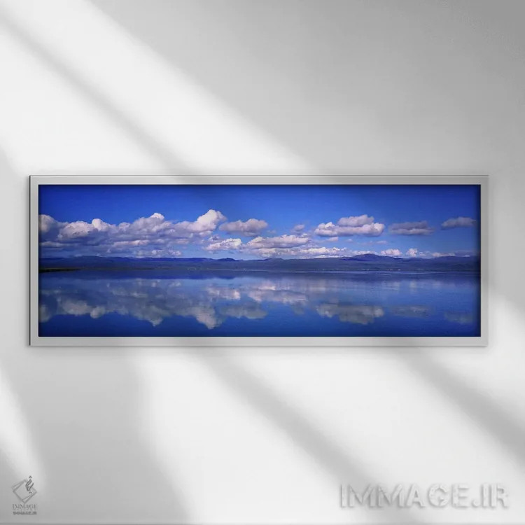 تابلو دکوراتیو Iceland,ابرهای پنبه ای و انعکاس آن ها در اولفوسا، ایسلن… اثر پانورامیک ایمجز - نمای قابدار سفید