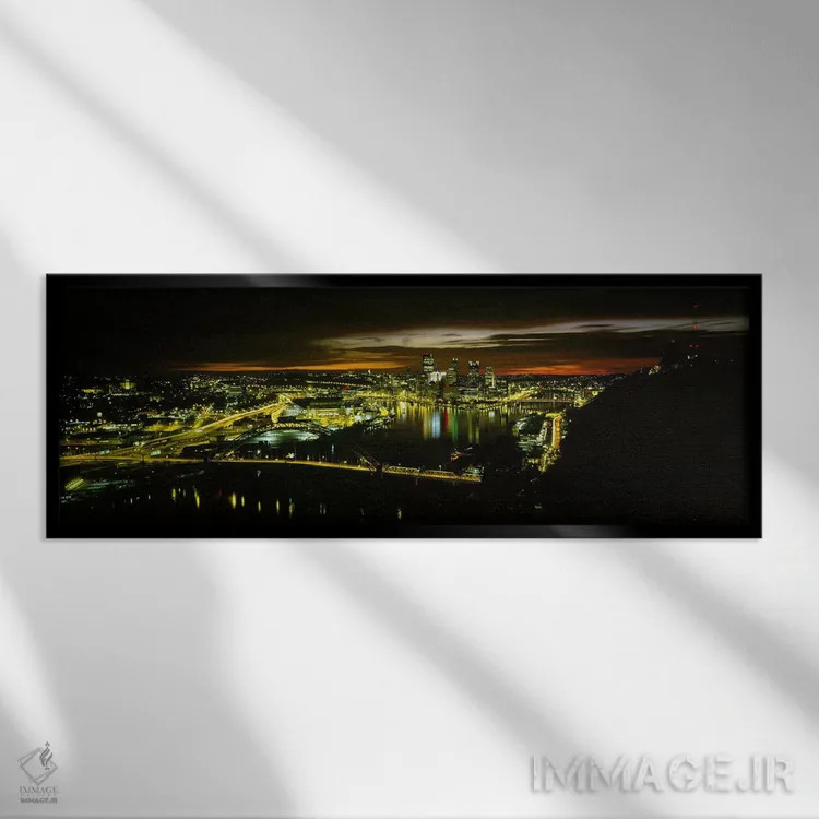 تابلو دکوراتیو Pennsylvania, USA,نمای بالا از ساختمان های روشن شده در… اثر پانورامیک ایمجز - نمای قابدار مشکی