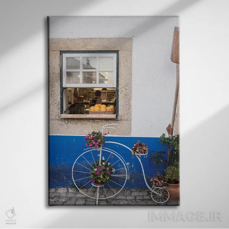 تابلو دکوراتیو Obidos, Portugal,گلدان دوچرخه ای بامزه مقابل یک نانوایی در شه… اثر جولی اگرز - نمای روبهرو روی دیوار