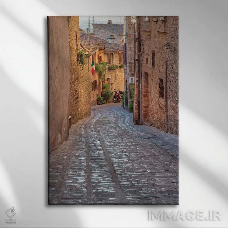تابلو دکوراتیو Umbria Cobblestone Street In The Town Of Spello,ایتالیا، آمبر… اثر جولی اگرز - نمای روبهرو روی دیوار