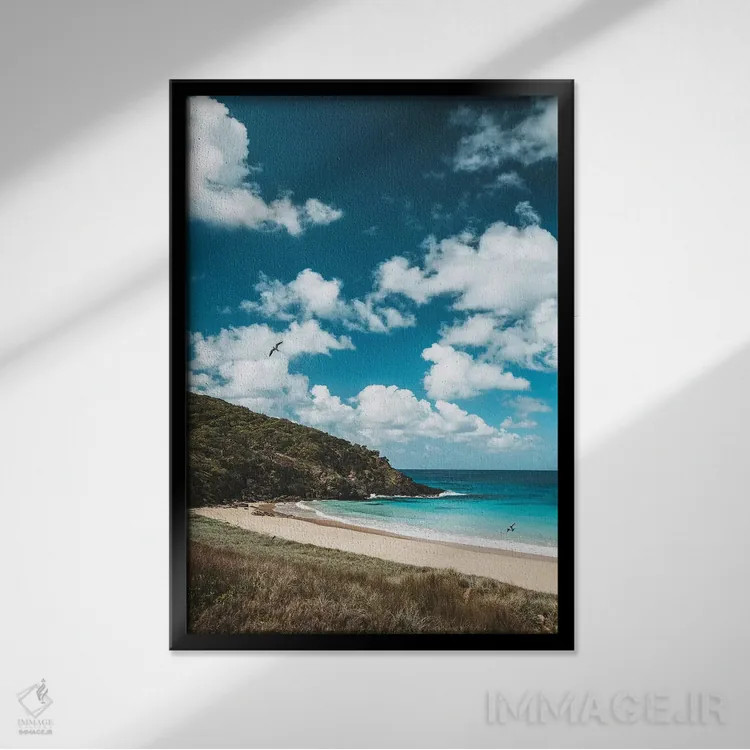 تابلو دکوراتیو ساحل جزیره خلوت با آب آبی اثر جیمز وودیکا - نمای قابدار مشکی