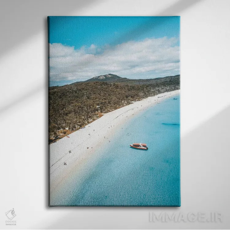 تابلو دکوراتیو نمای هوایی ساحل جزیره با آب آبی و شن سفید اثر جیمز وودیکا - نمای روبهرو روی دیوار