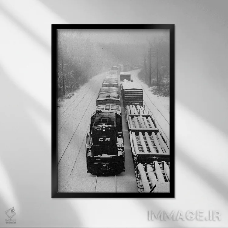 تابلو دکوراتیو دو قطار باری در حال حرکت روی ریل های پوشیده از برف اثر تصاویر وینتج - نمای قابدار مشکی