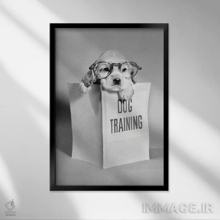 تابلو دکوراتیو توله سگ کاکر اسپانیل با عینک و دست روی کتاب راهنمای آموزش… اثر تصاویر وینتج - نمای قابدار مشکی