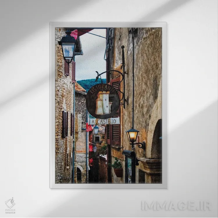 تابلو دکوراتیو خیابان قرون وسطایی با تابلوها و چراغ ها، سرمونتا، ایتالیا اثر جورج اوزه - نمای قابدار سفید